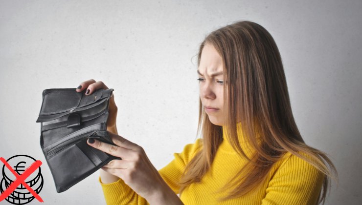 Ragazza contrariata davanti al portafoglio vuoto